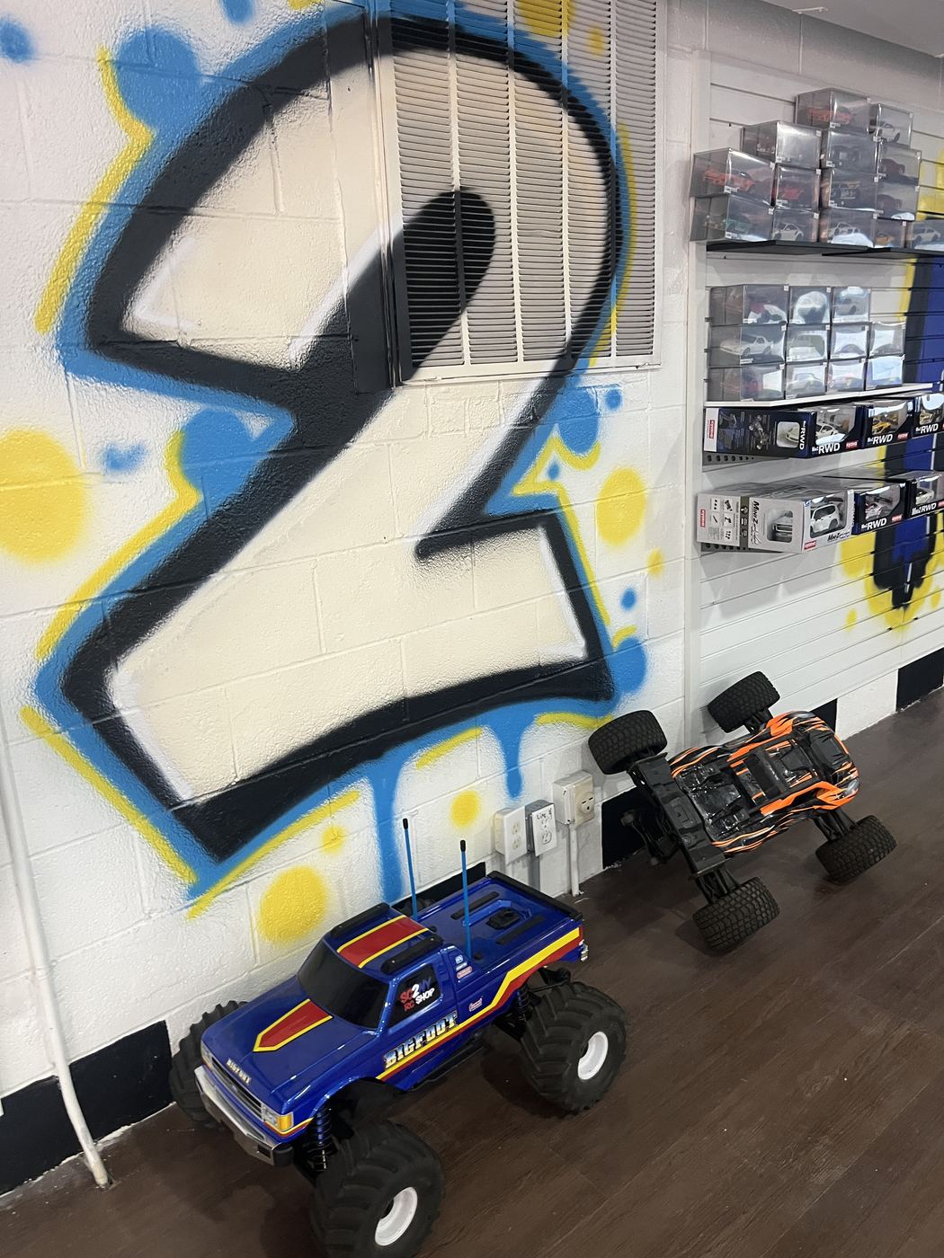 RC monster truck in front of the SC2NY graffiti mural