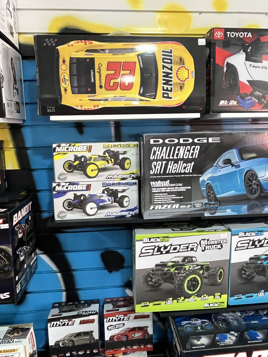 RC cars and Kyosho kits on the graffiti wall at SC2NY